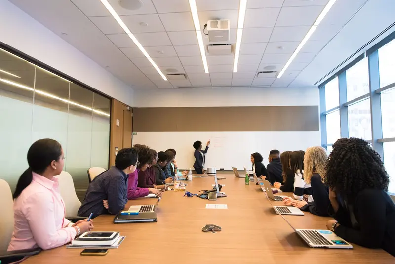 Team working at a long table with laptops